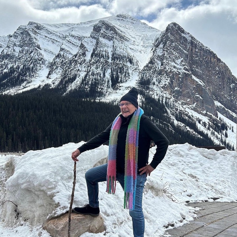 Guest posing in front of a mountain.