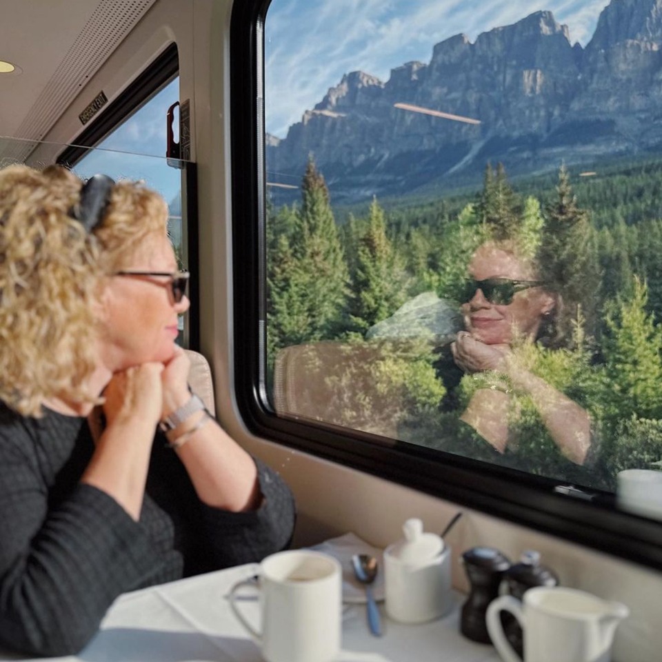 Woman gazes out train window